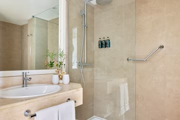 a bathroom with a shower and sink