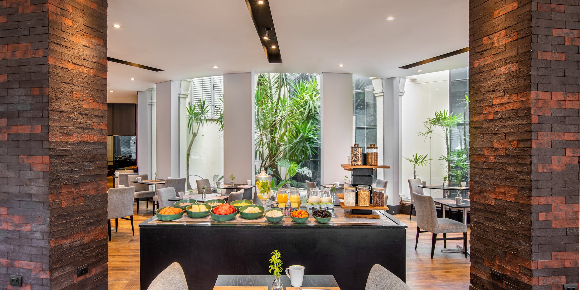 a room with a table and chairs and a table with food on it