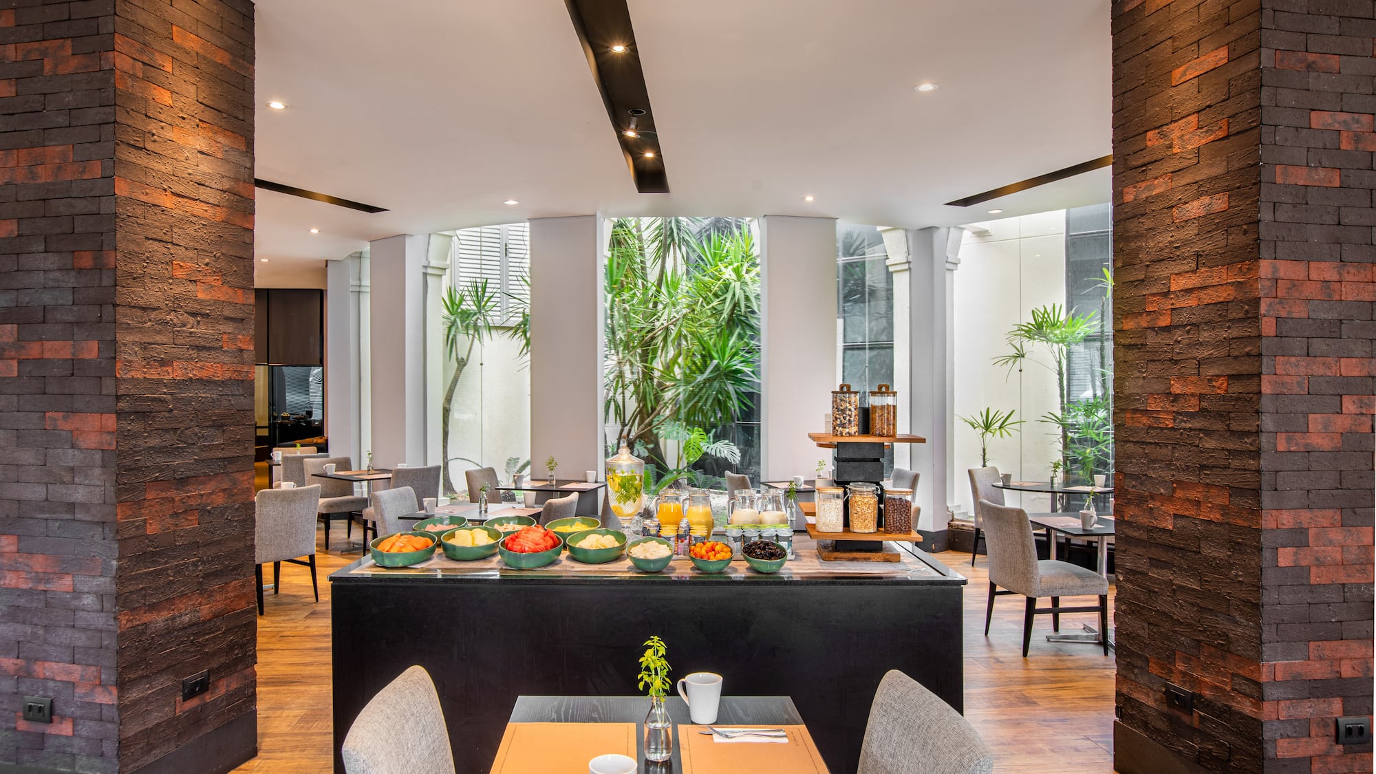 a room with a table and chairs and a table with food on it