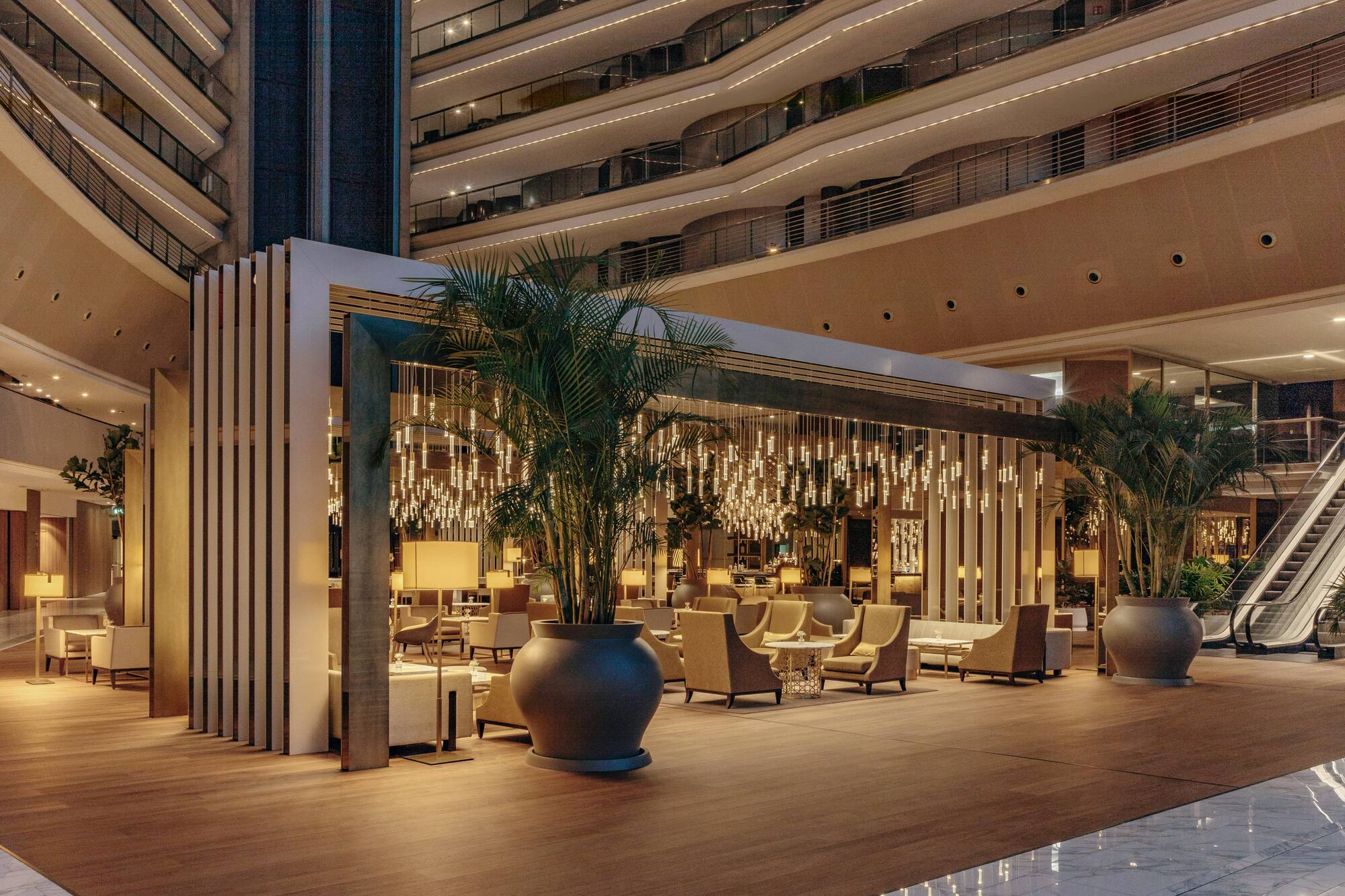 Modern hotel atrium lounge with stylish seating and unique lighting.
