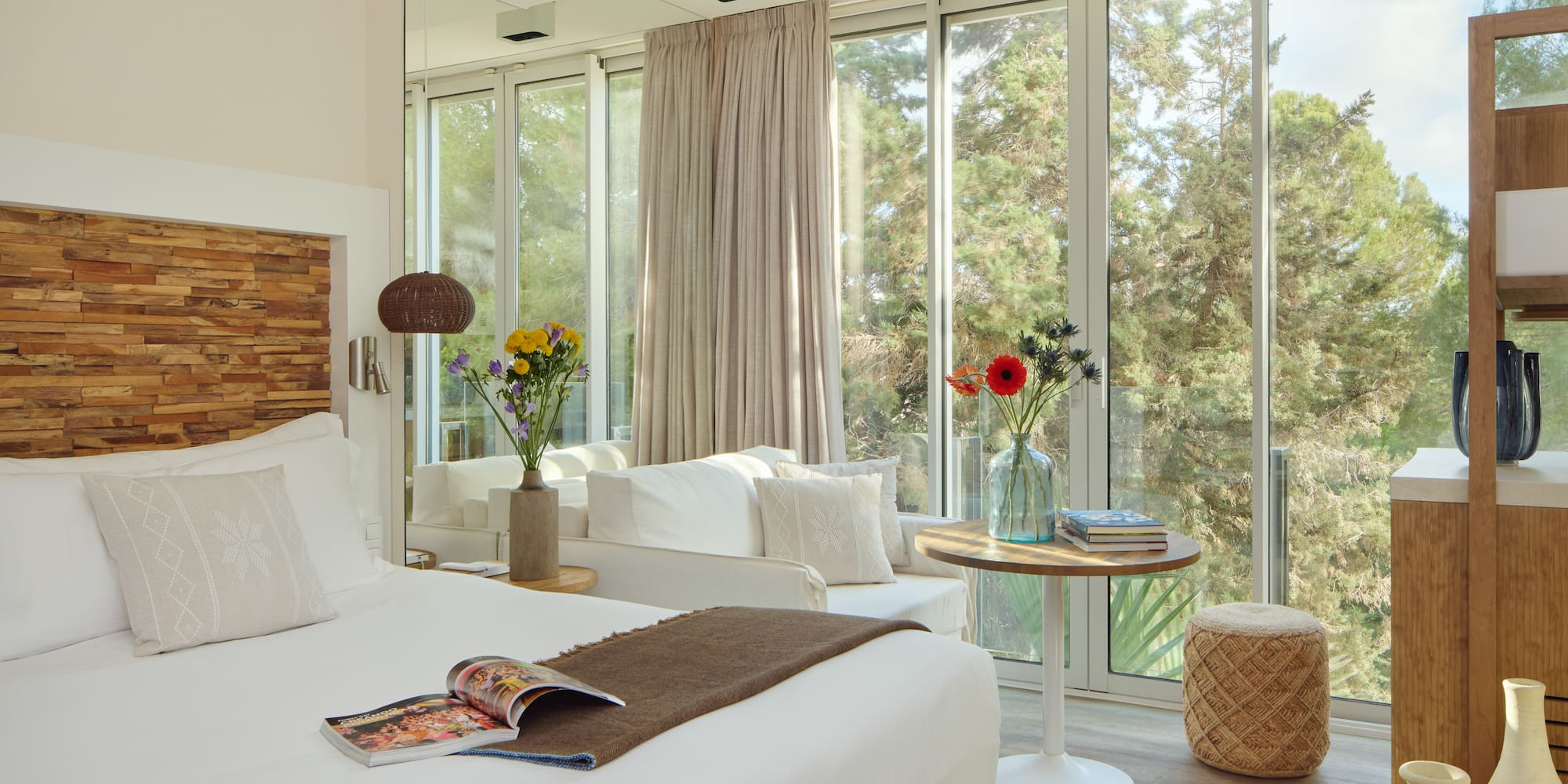 a room with a bed and a table and chairs