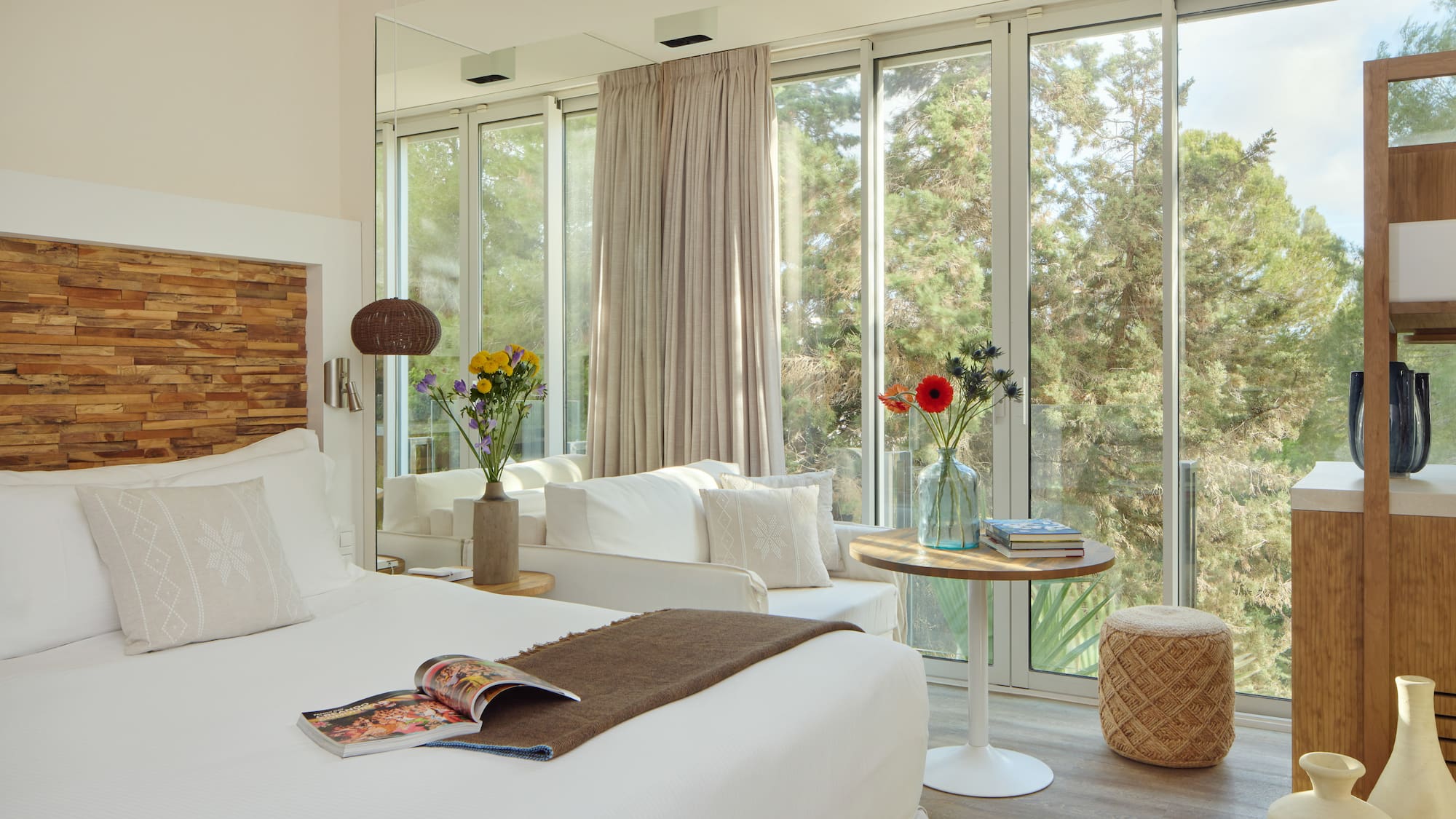 a room with a bed and a table and chairs