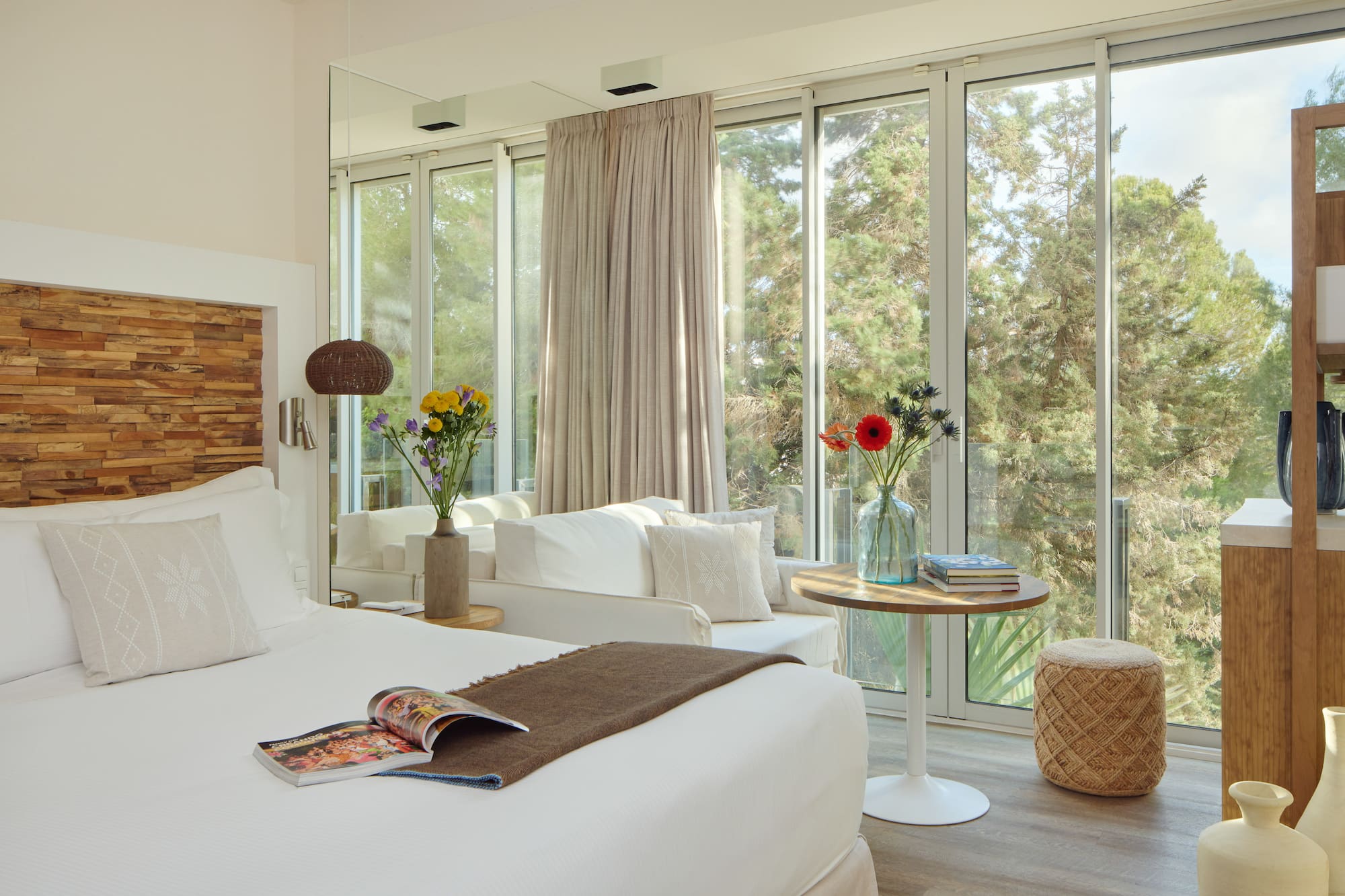 a room with a bed and a table and chairs