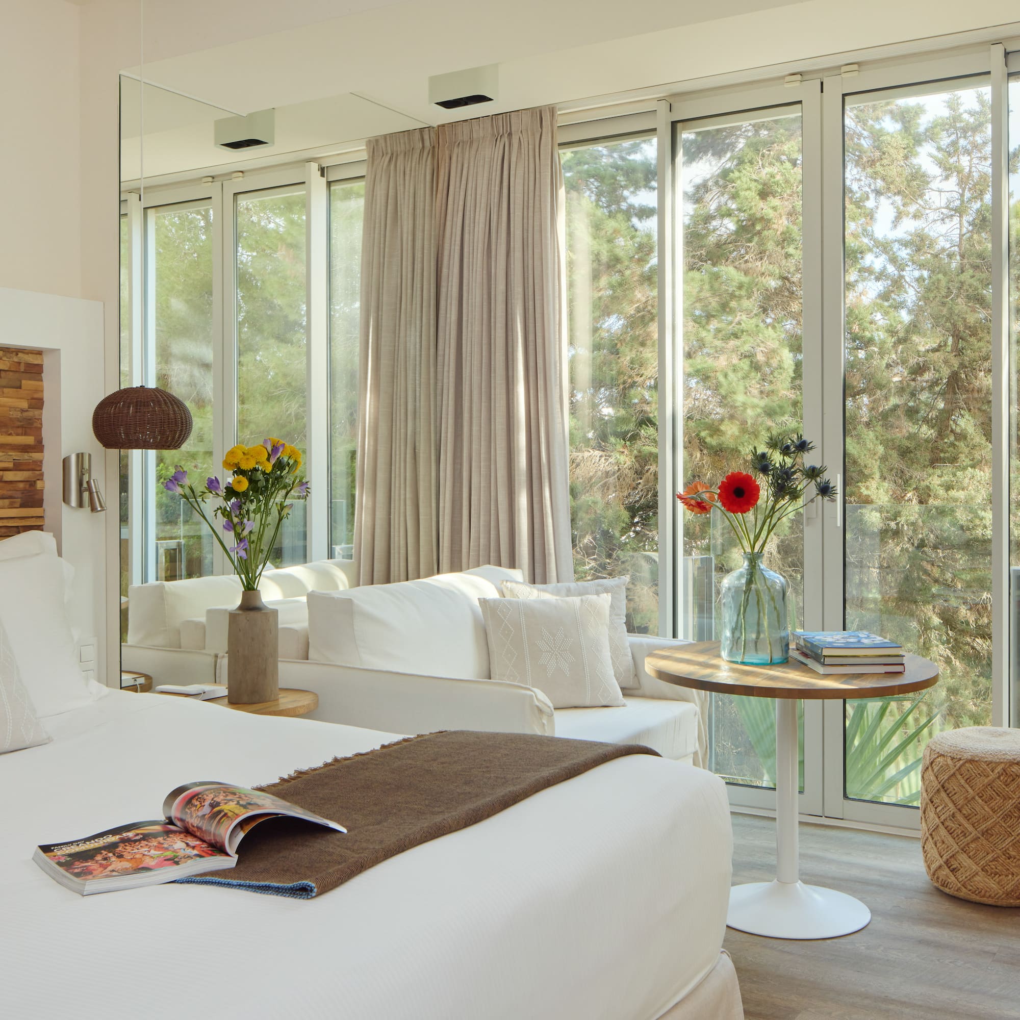 a room with a bed and a table and chairs