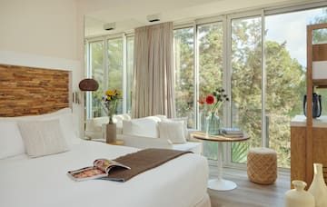 a room with a bed and a table and chairs