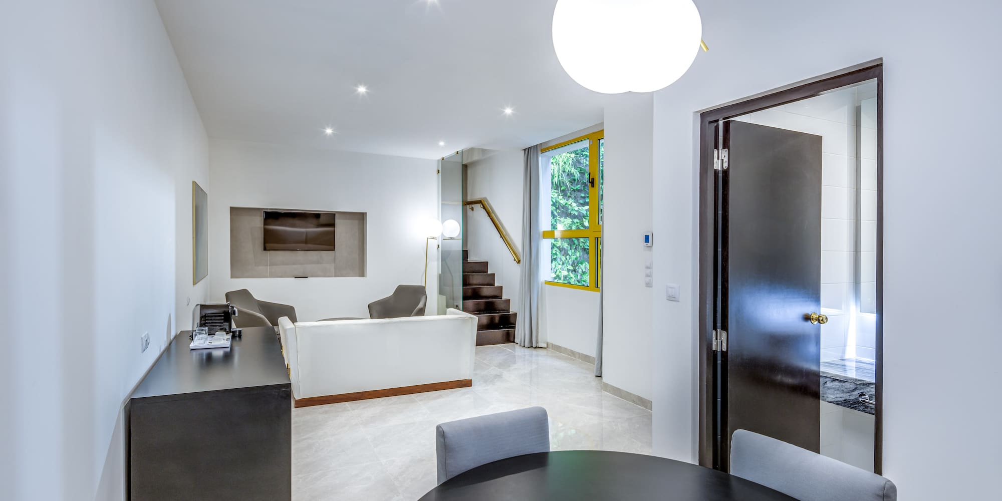 a room with a round table and chairs