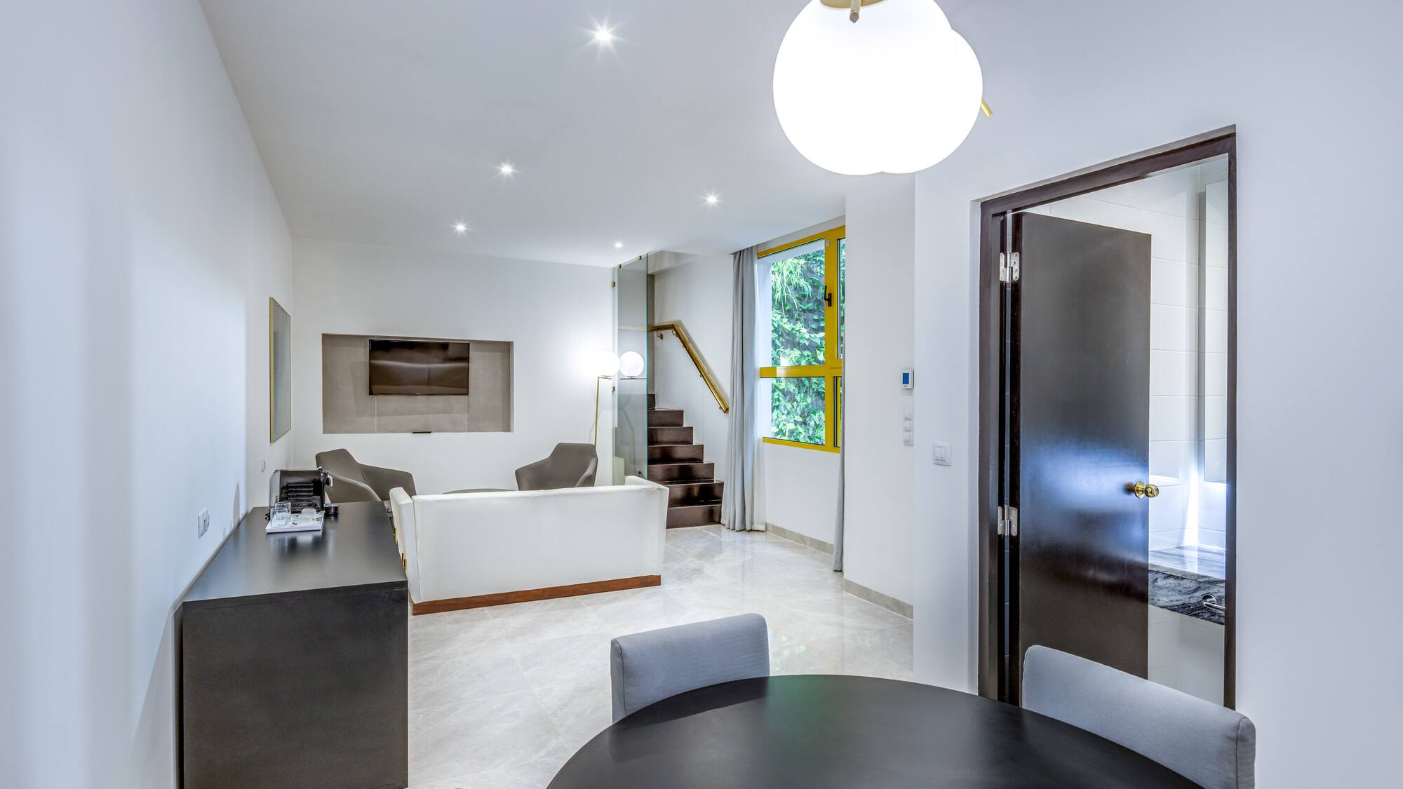 a room with a round table and chairs