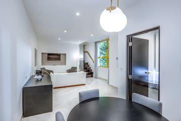 a room with a round table and chairs