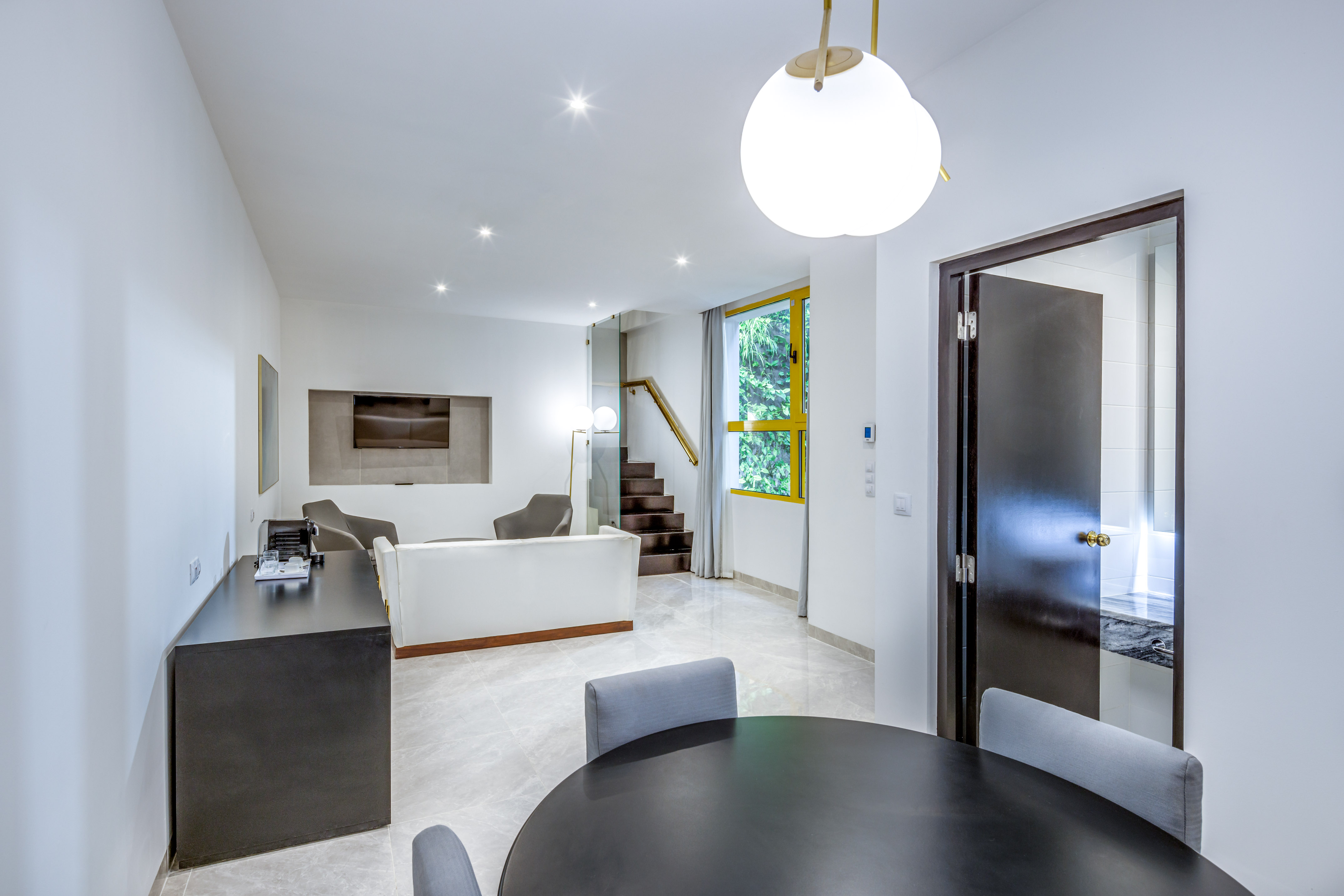 a room with a round table and chairs