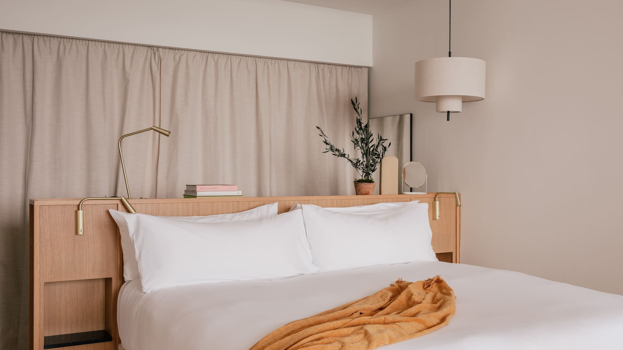 a bed with white sheets and a lamp