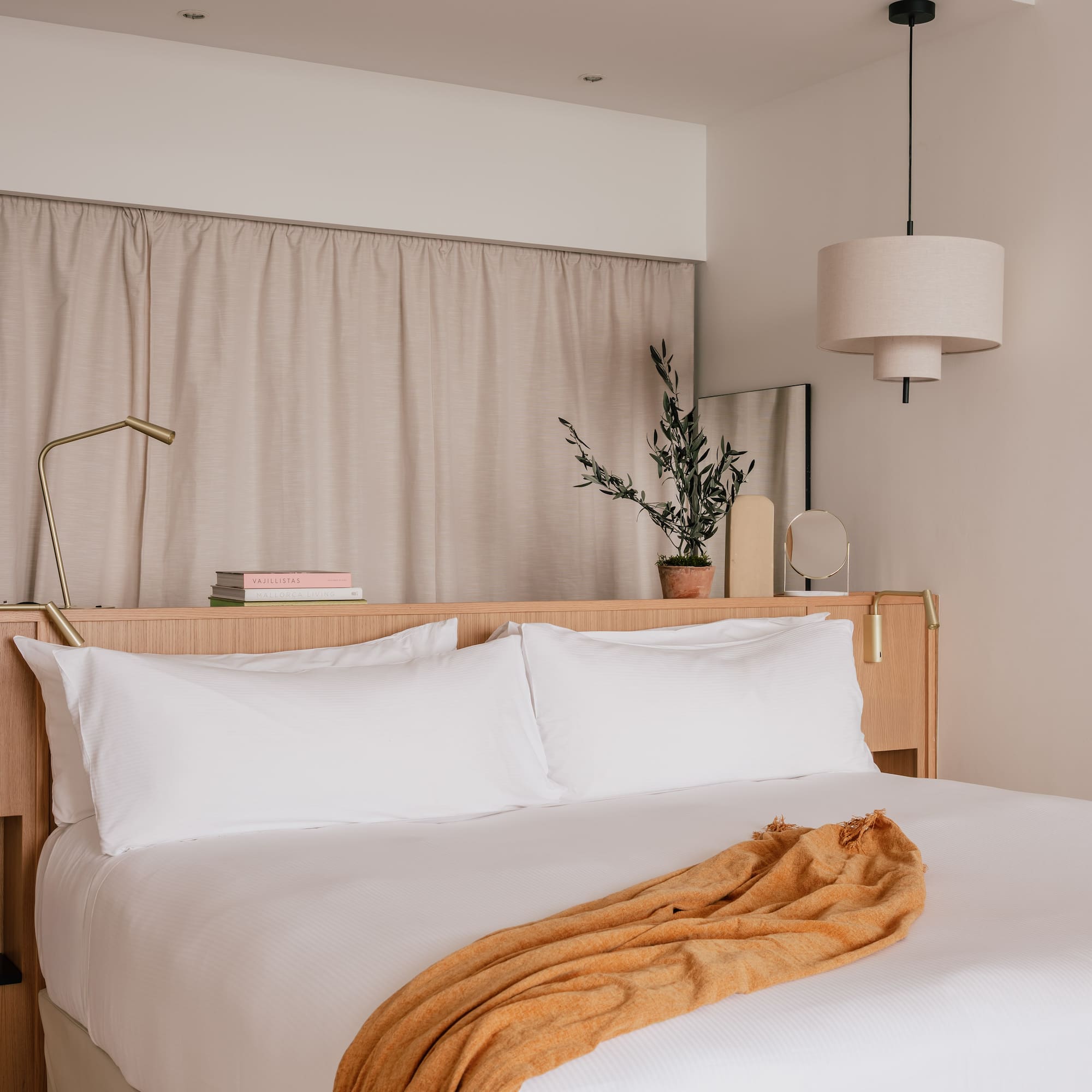 a bed with white sheets and a lamp