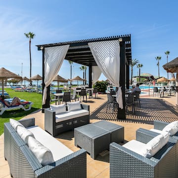 a pool with a gazebo and chairs