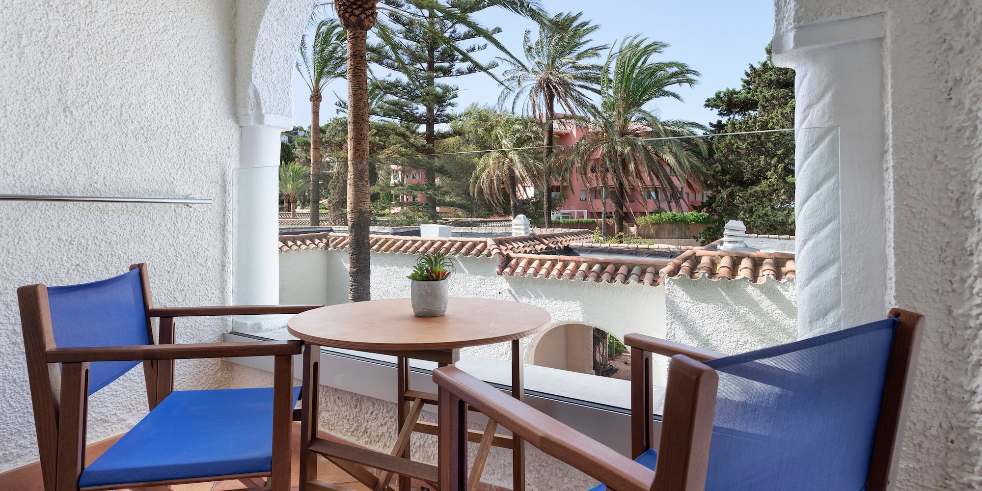 a table and chairs on a balcony