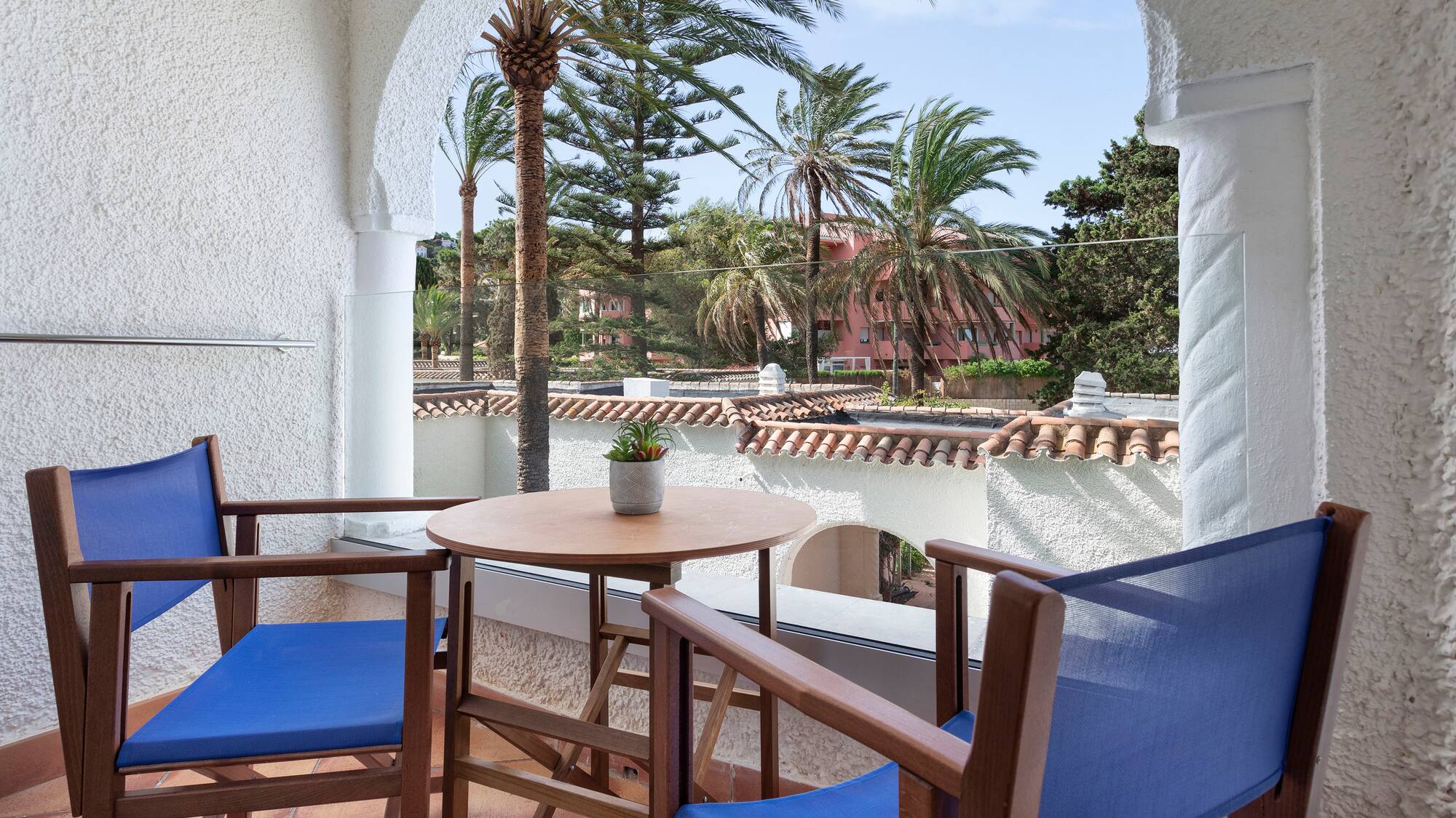a table and chairs on a balcony