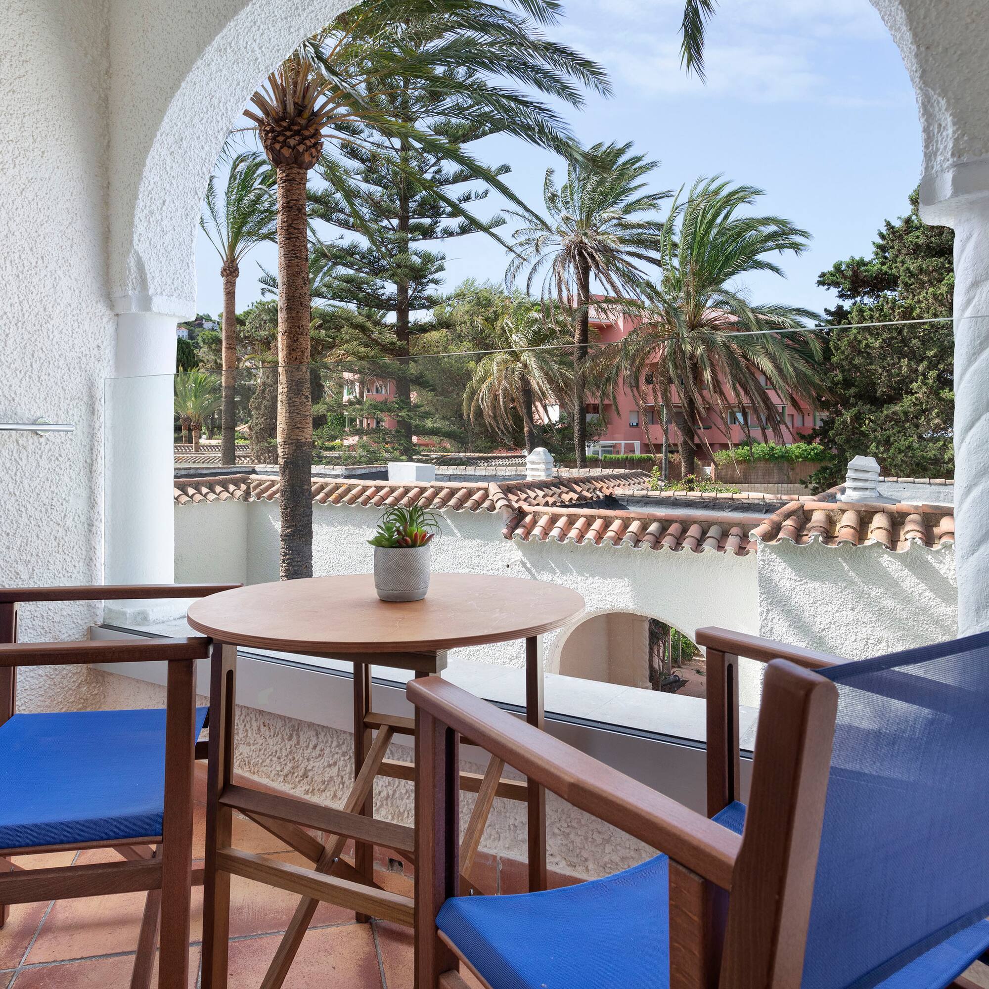 a table and chairs on a balcony