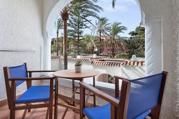 a table and chairs on a balcony
