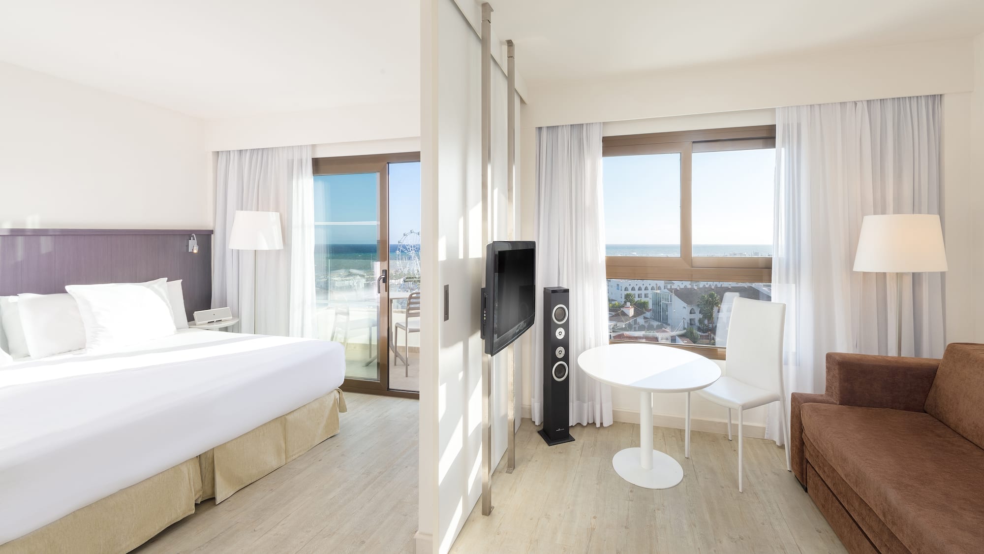 a room with a bed and a television