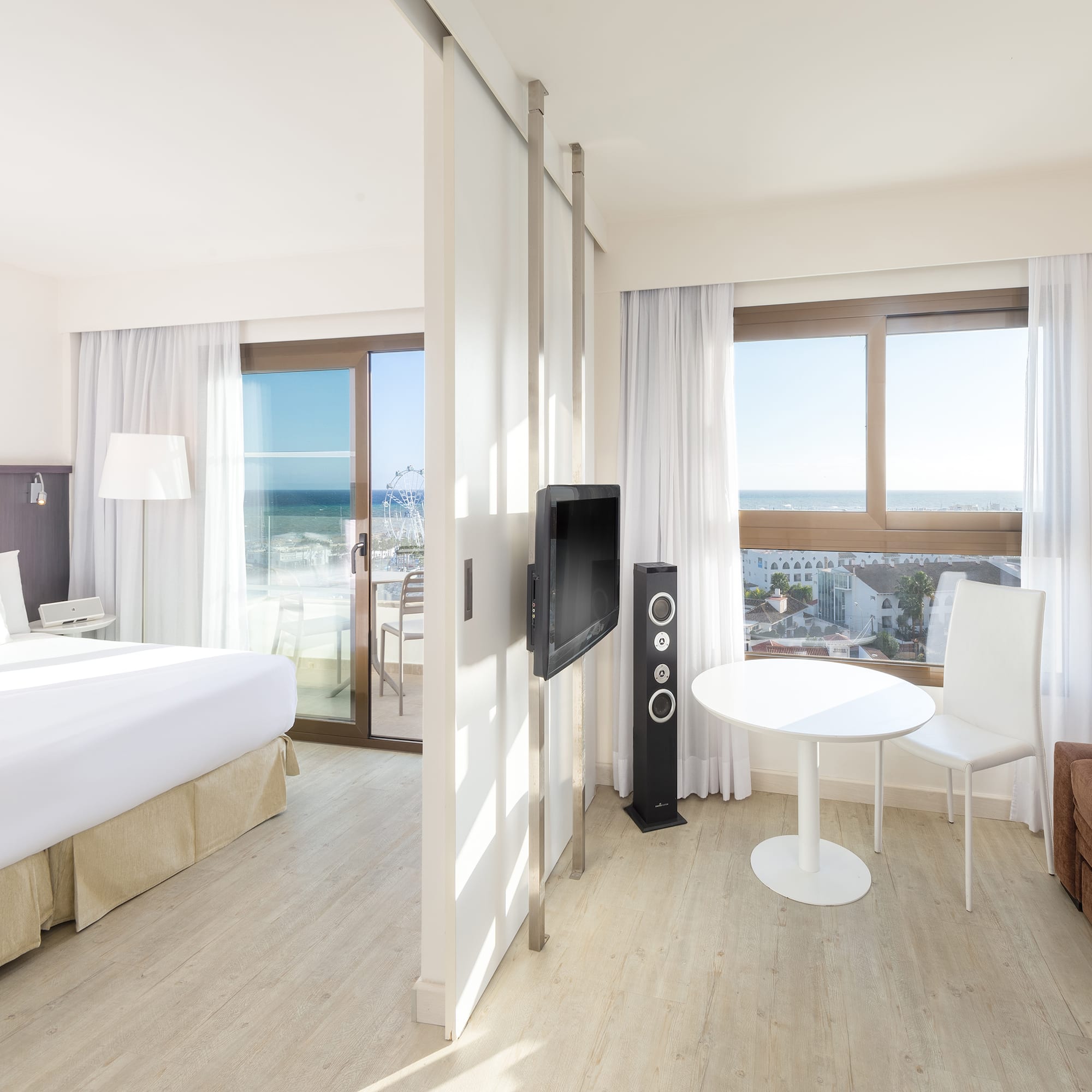 a room with a bed and a television