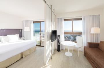 a room with a bed and a television