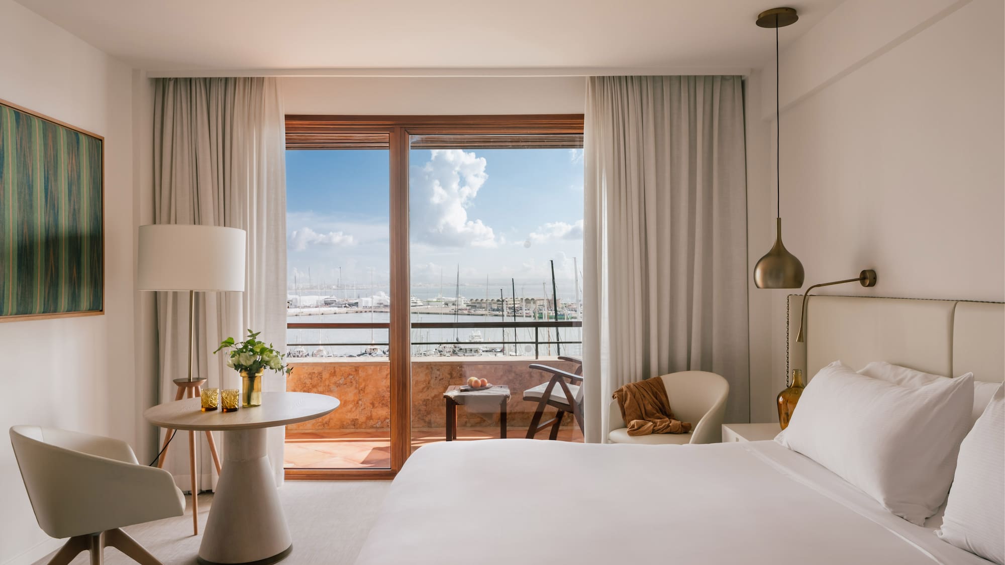 a bedroom with a large window and a bed