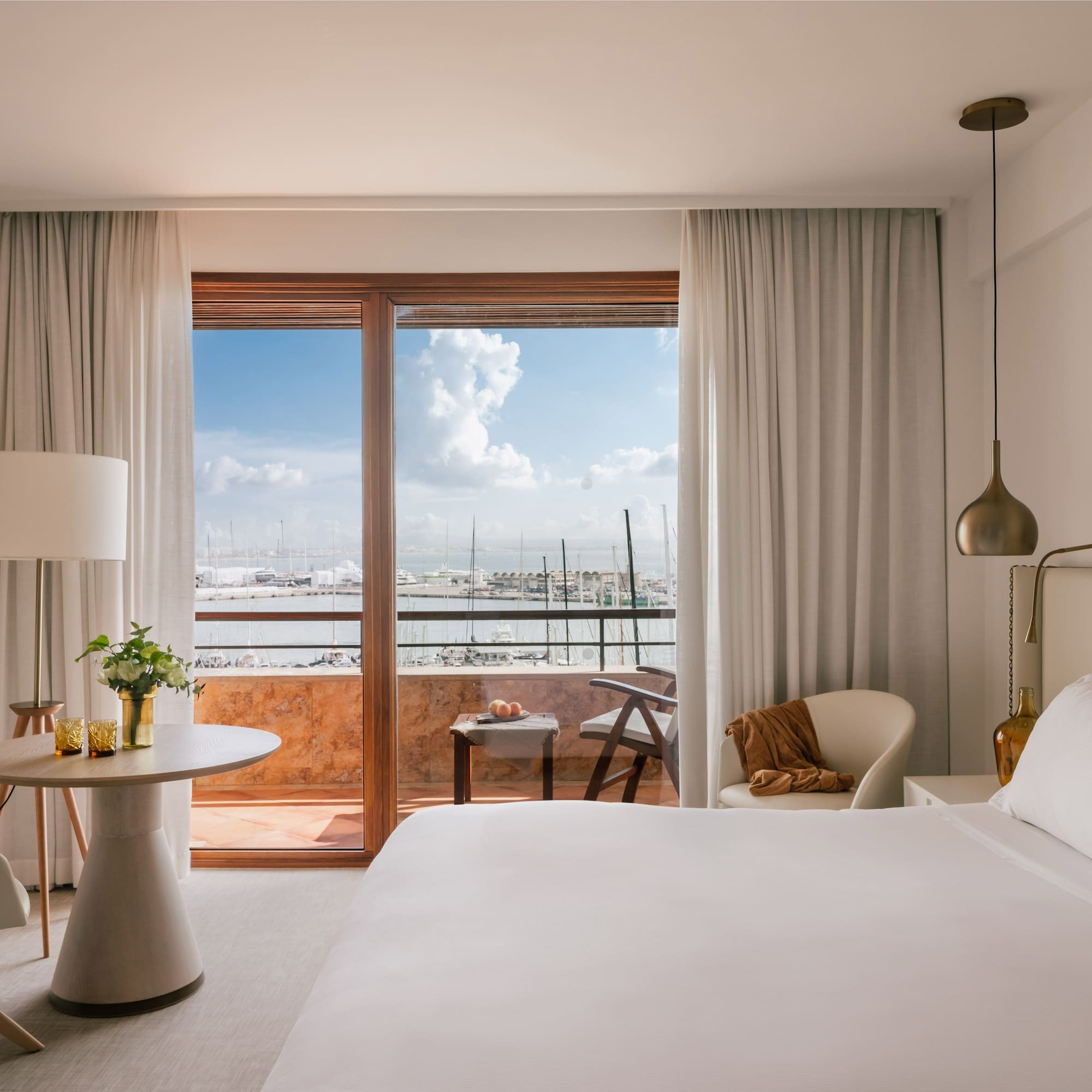 a bedroom with a large window and a bed