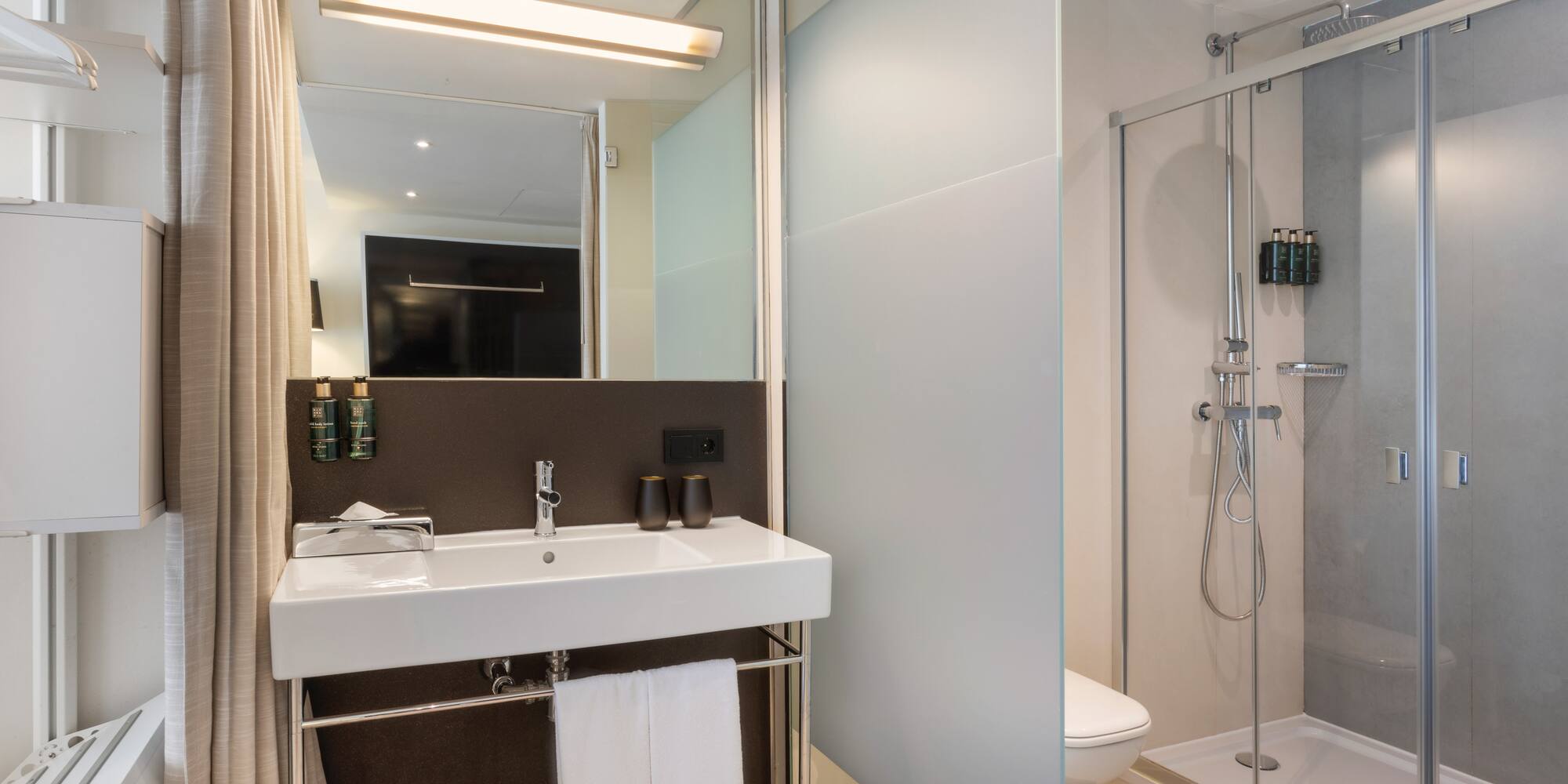 a bathroom with a shower and sink