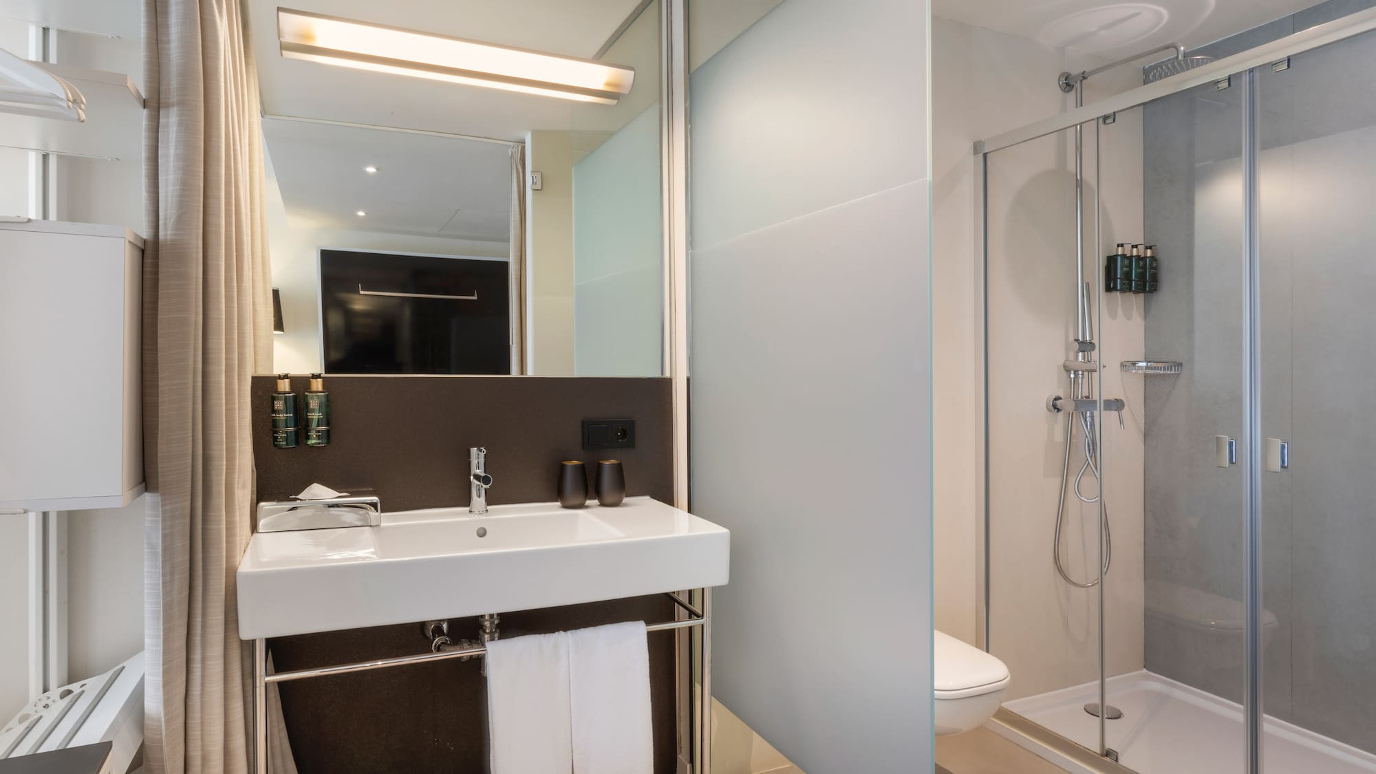 a bathroom with a shower and sink