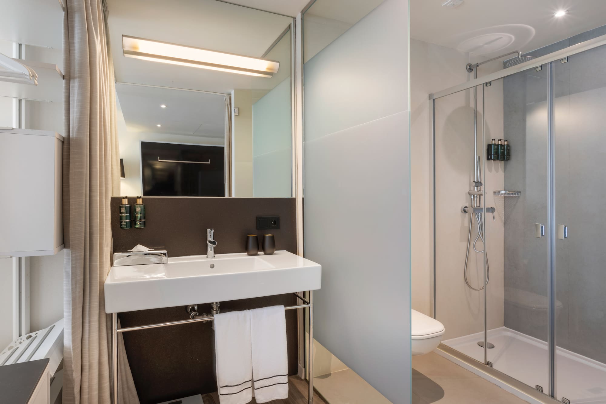 a bathroom with a shower and sink