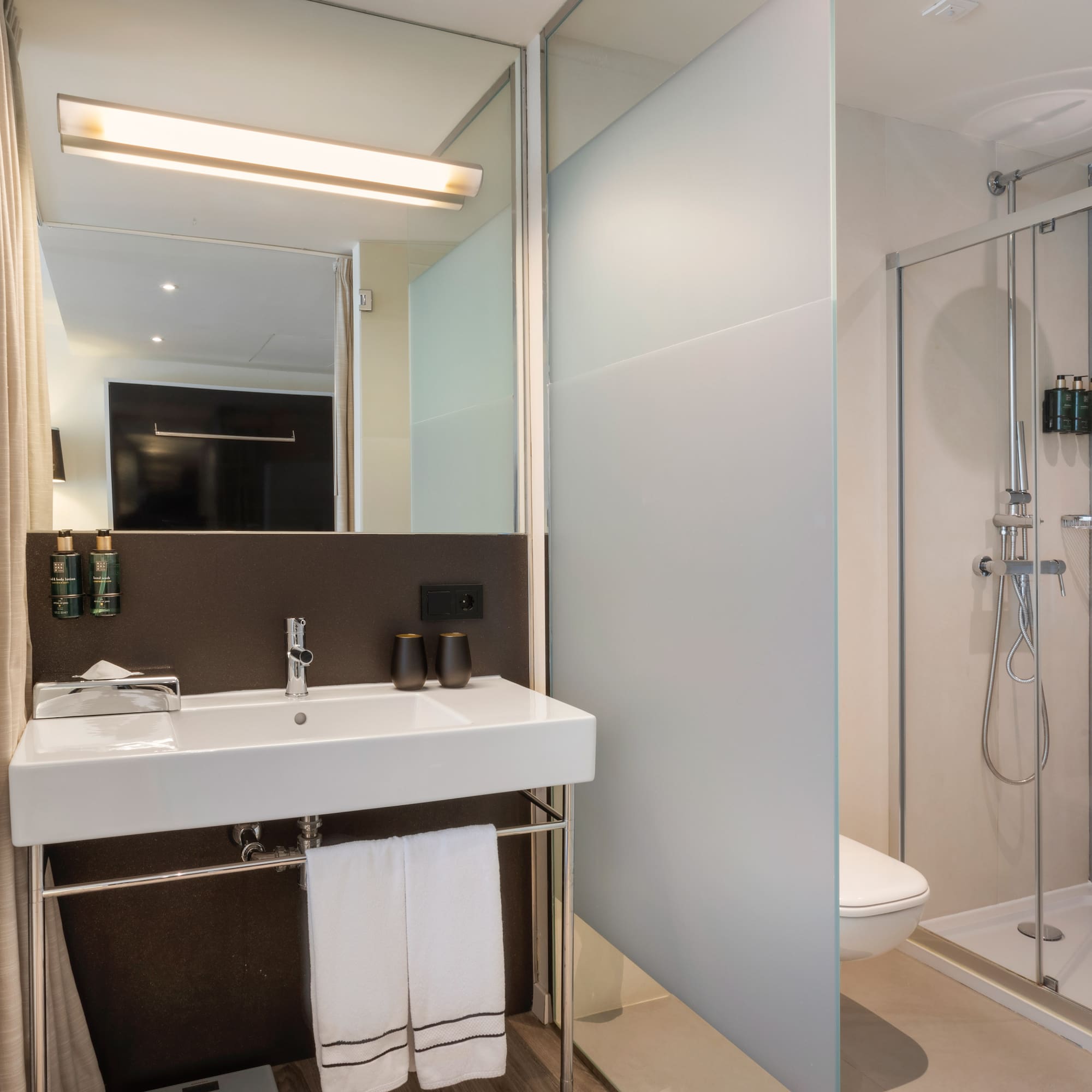 a bathroom with a shower and sink