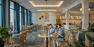 a man and woman sitting at a table in a restaurant