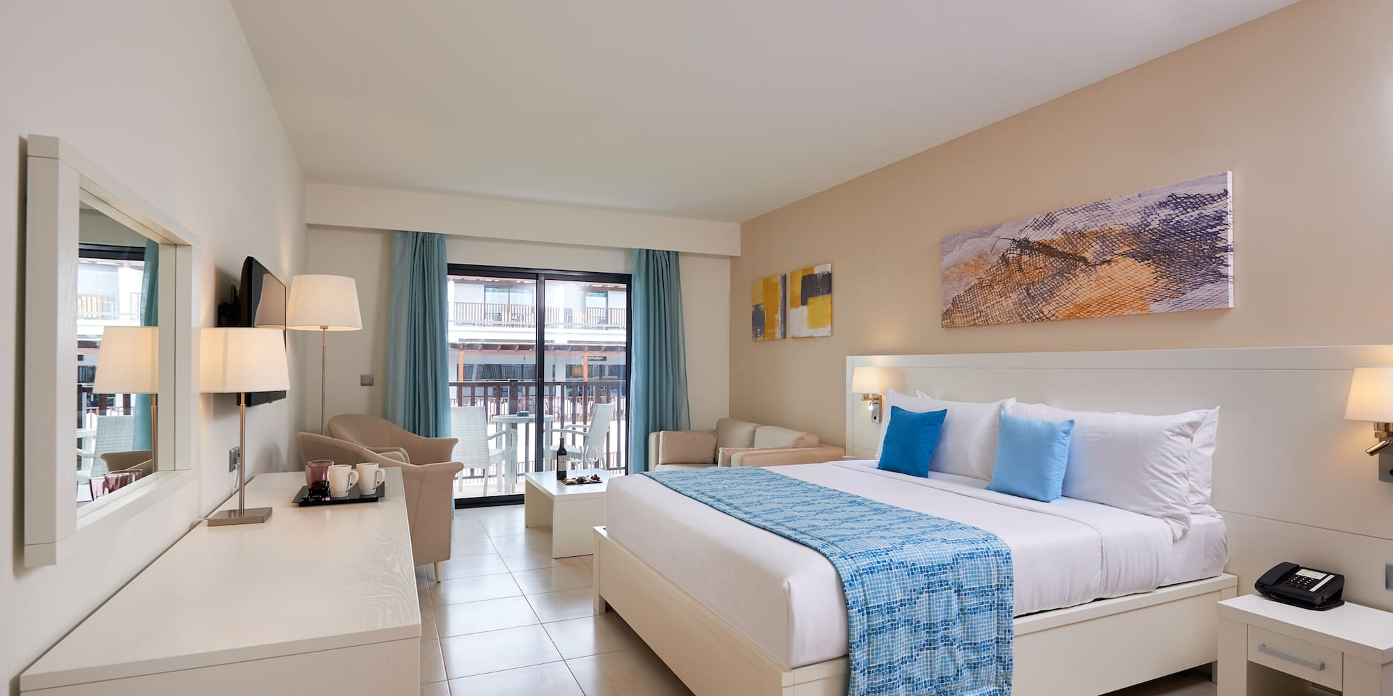 a room with a bed and a table and chairs