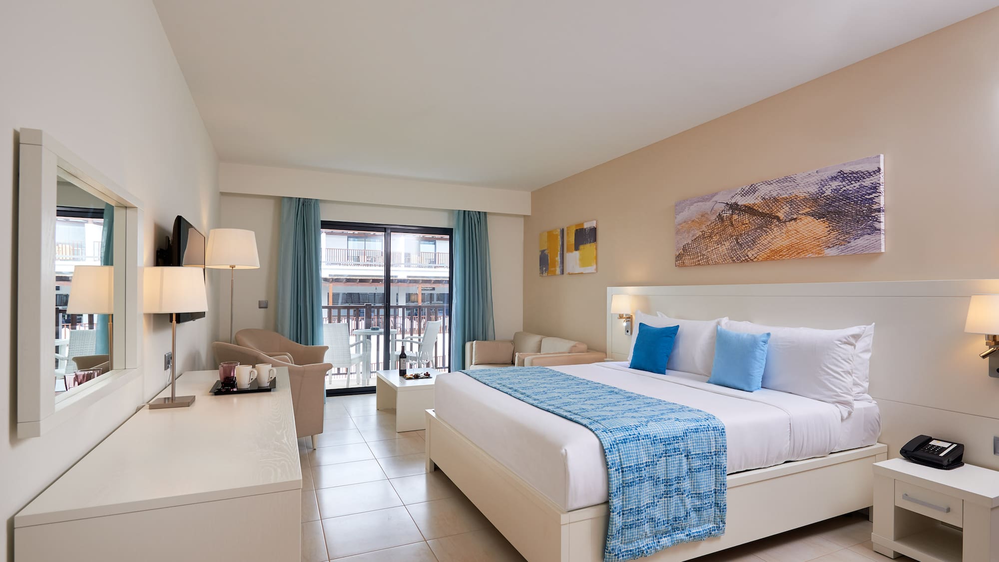 a room with a bed and a table and chairs