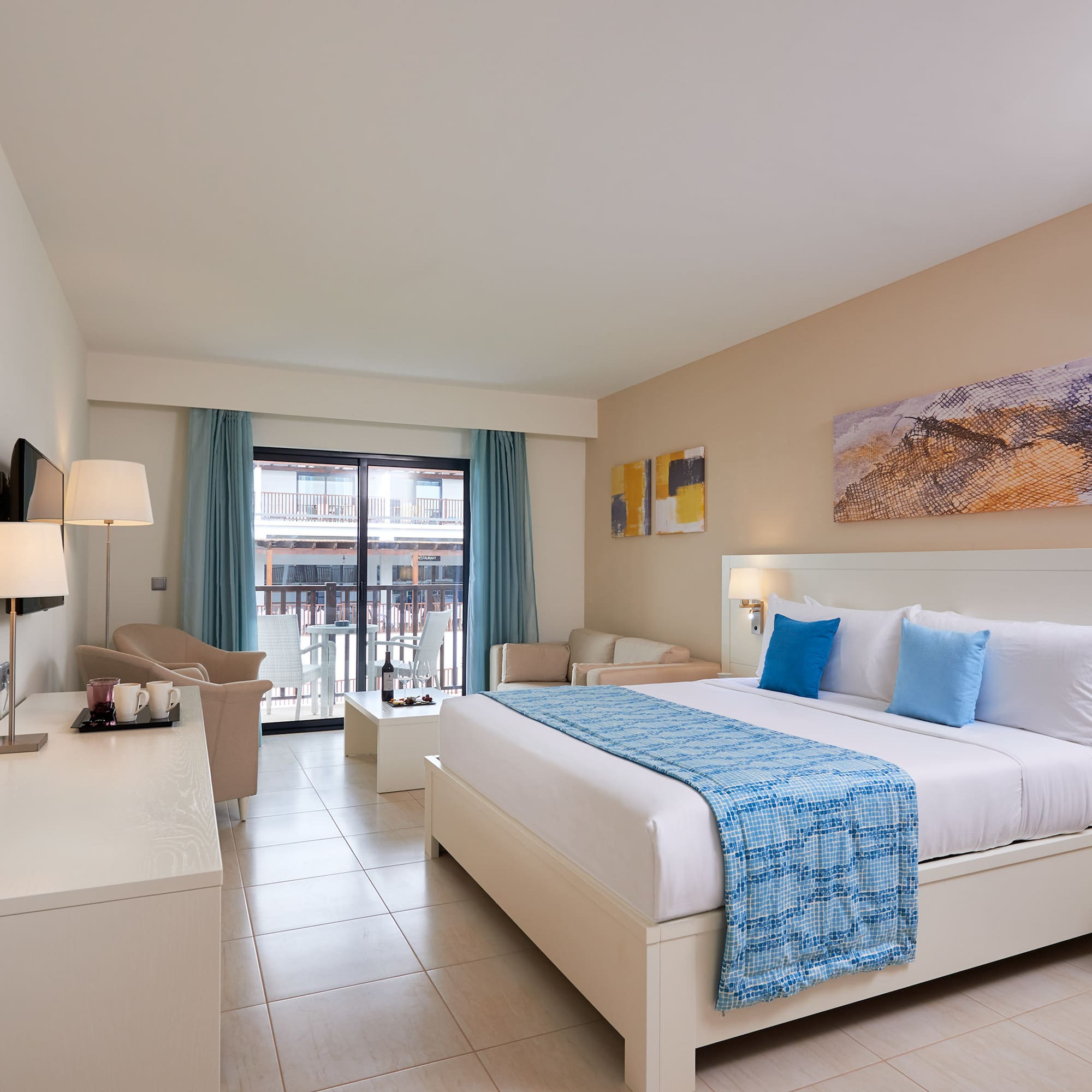 a room with a bed and a table and chairs