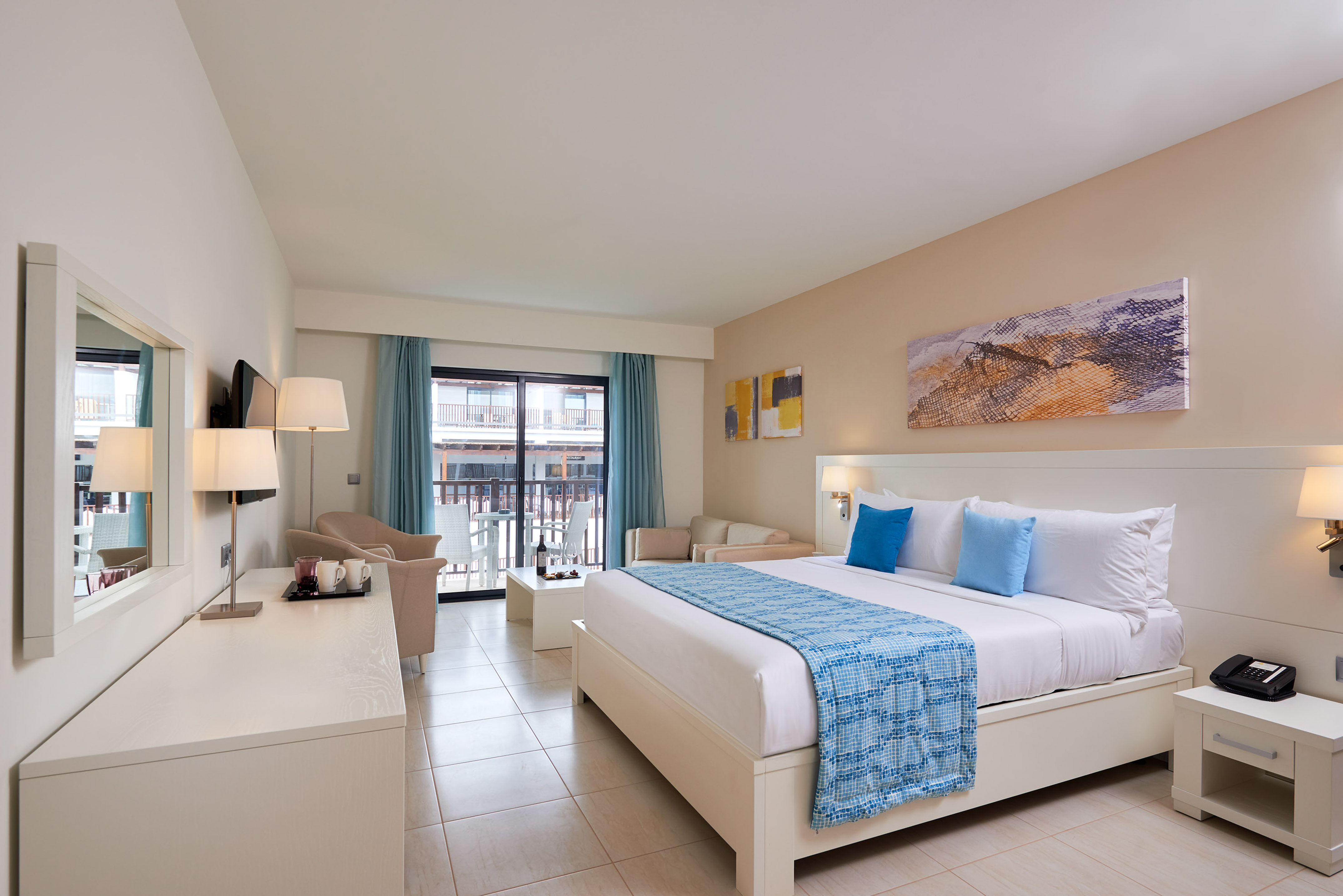 a room with a bed and a table and chairs