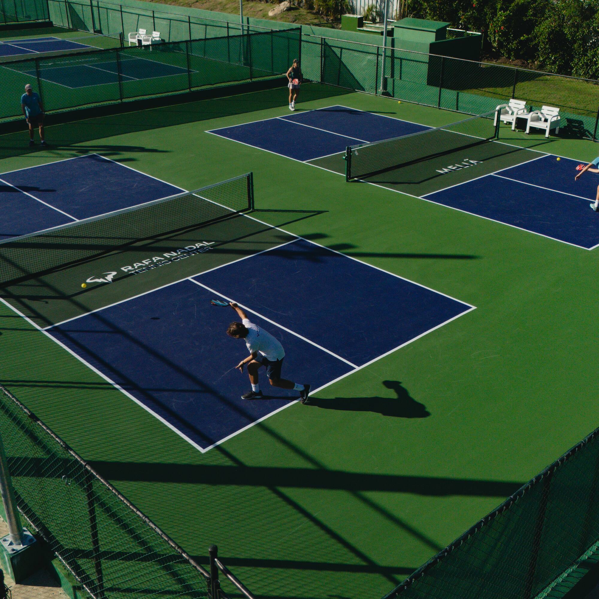 a group of people playing tennis