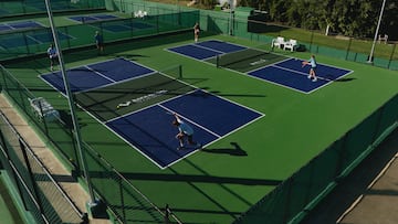 a group of people playing tennis