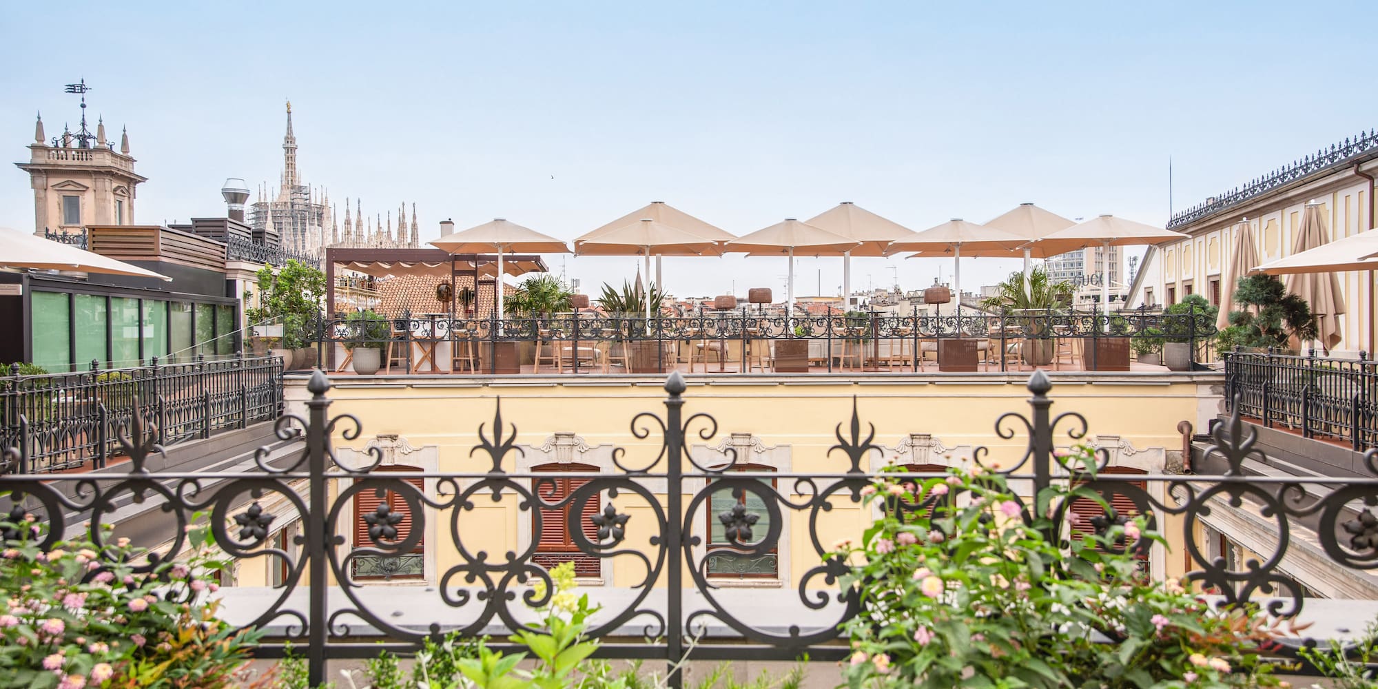 a fence with plants and flowers on it