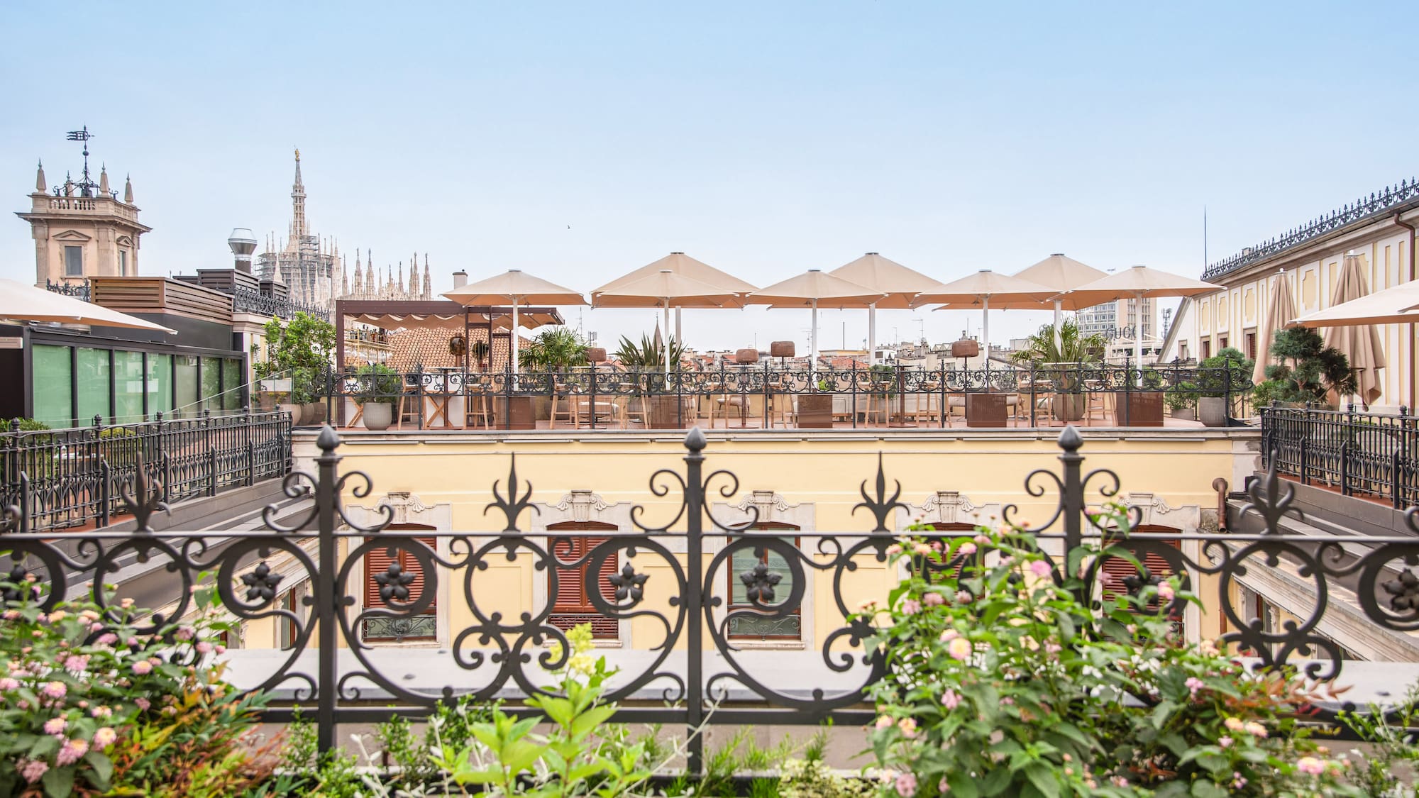 a fence with plants and flowers on it