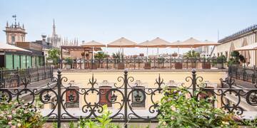 a fence with plants and flowers on it