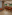 The Lobby Bar with orange bar stools, striped counter, and lounge seating.