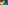 Coastal cove with golden sand beach, clear turquoise water, and forested cliffs.