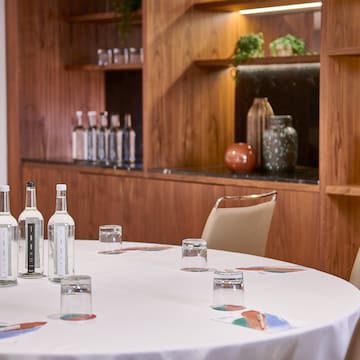 a table with white tablecloth and bottles on it
