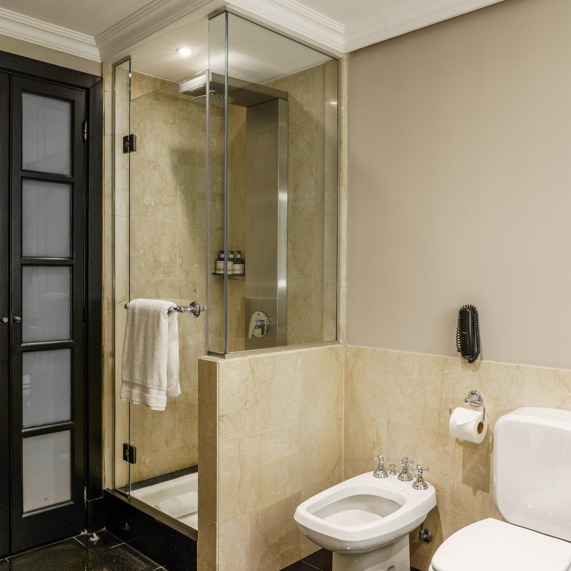 a bathroom with a glass shower and toilet
