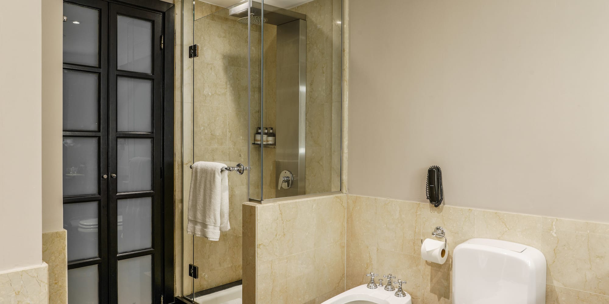a bathroom with a glass shower and toilet