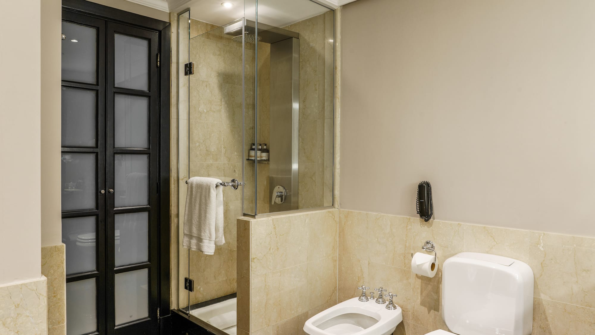 a bathroom with a glass shower and toilet