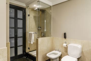 a bathroom with a glass shower and toilet