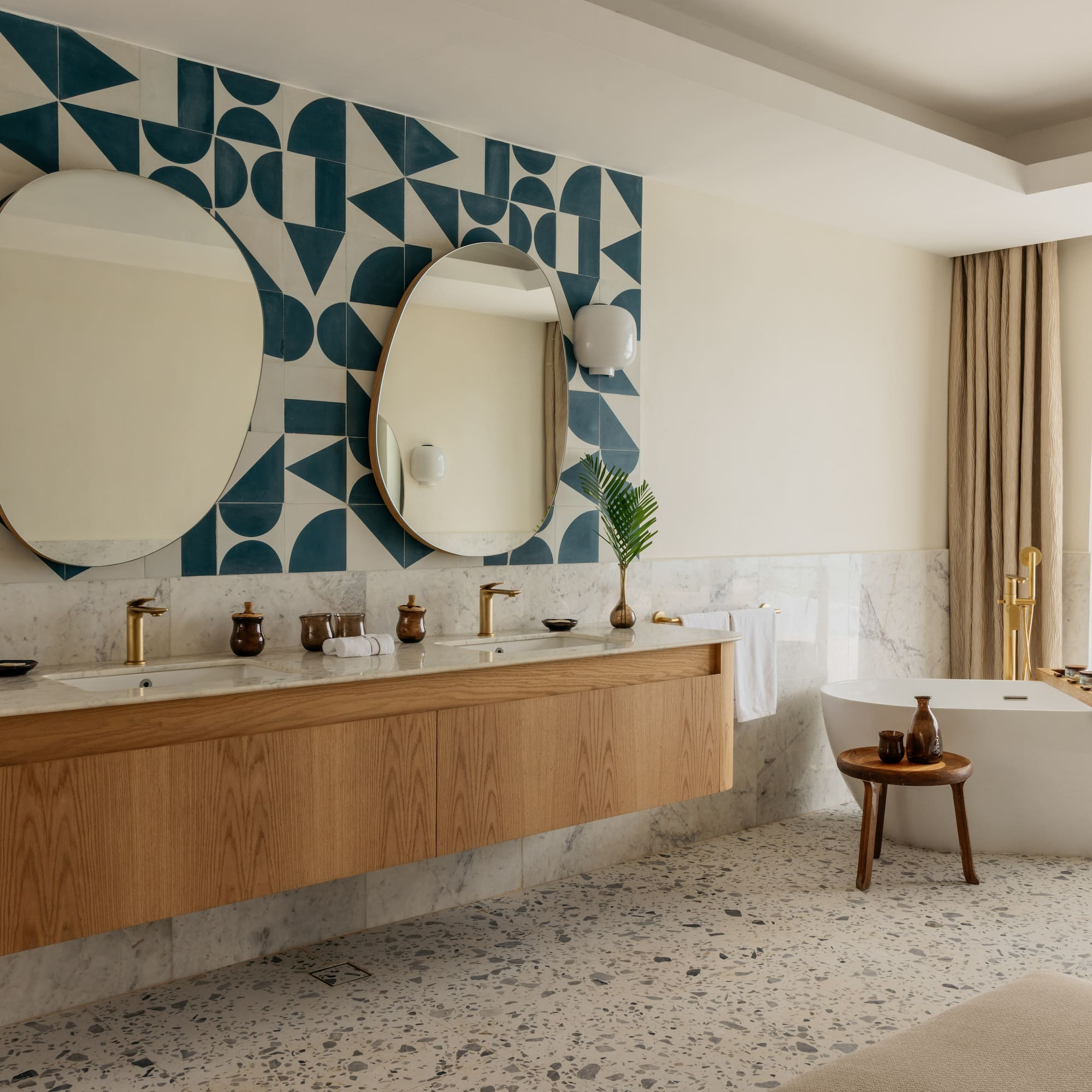 a bathroom with a bathtub and mirrors