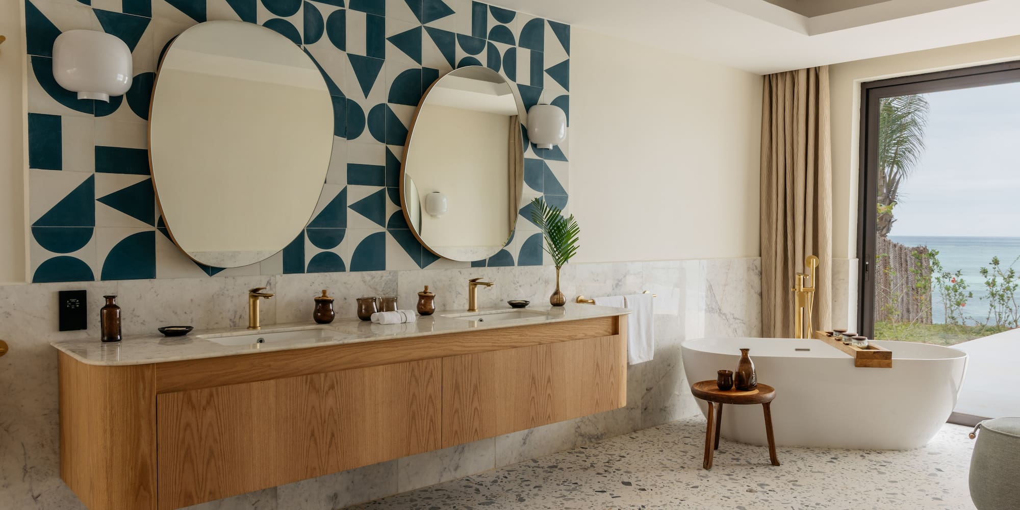 a bathroom with a bathtub and mirrors