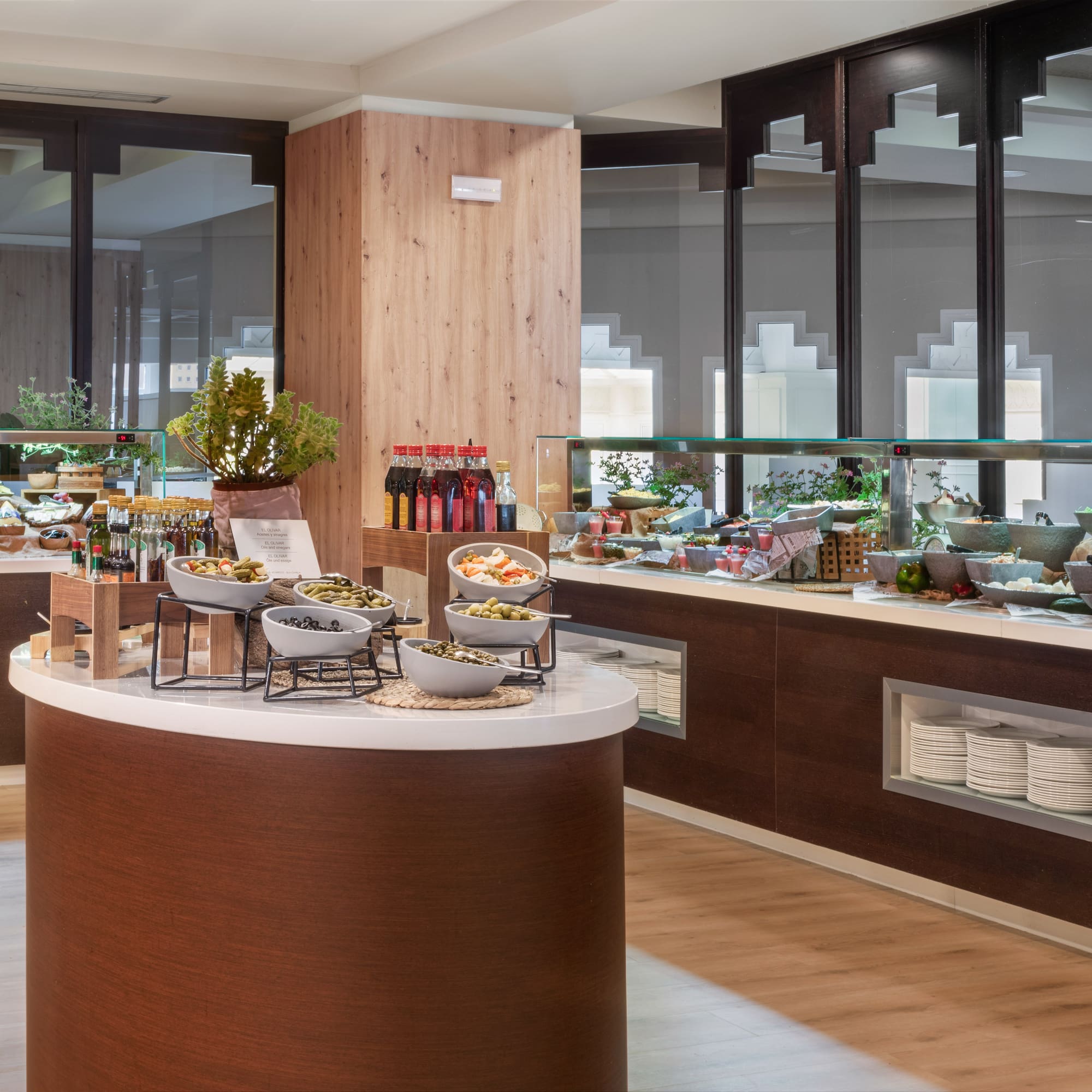 Amplio bufé de hotel con ensaladas frescas, aceitunas y aderezos.