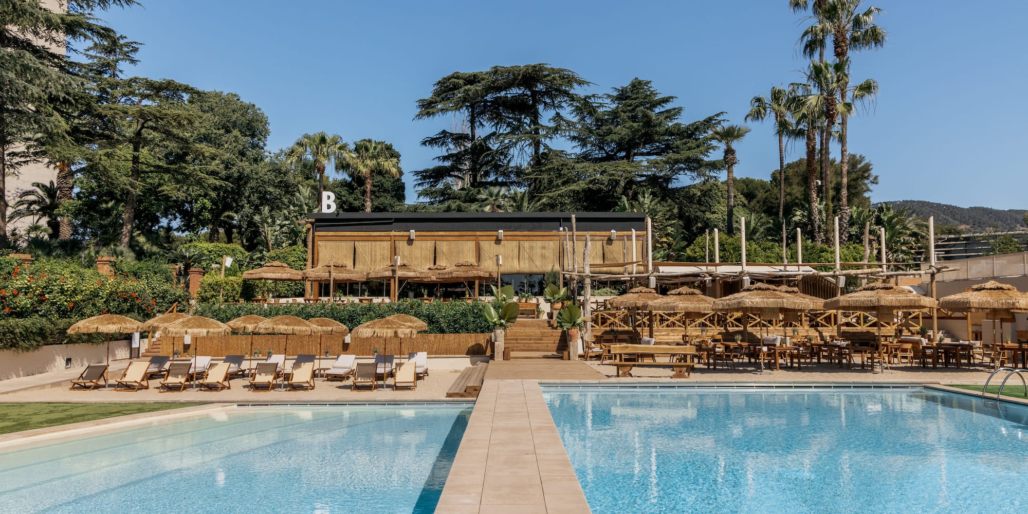 a pool with chairs and umbrellas